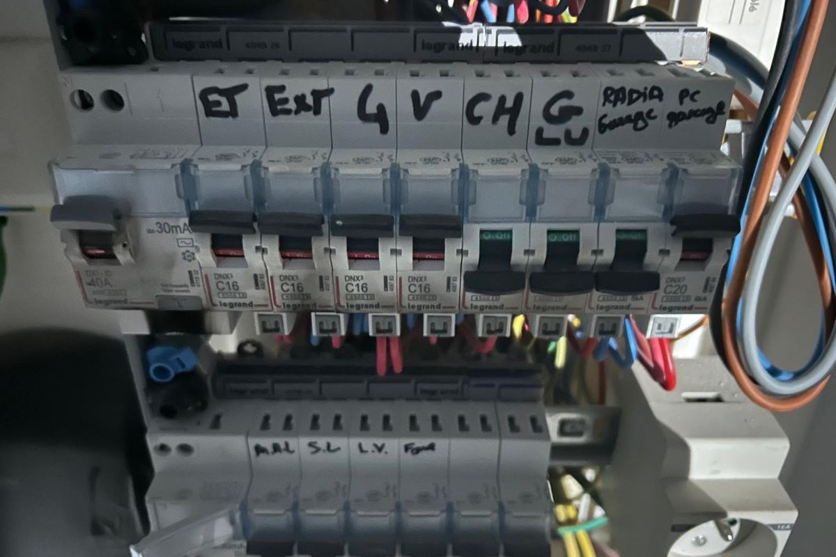 Tableau électrique dont les départs sont repérés au feutre sur la façade.
